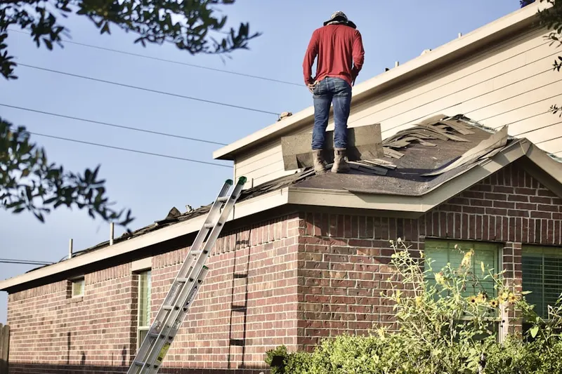 Professional roofer working on a residential roof in Bay Shore